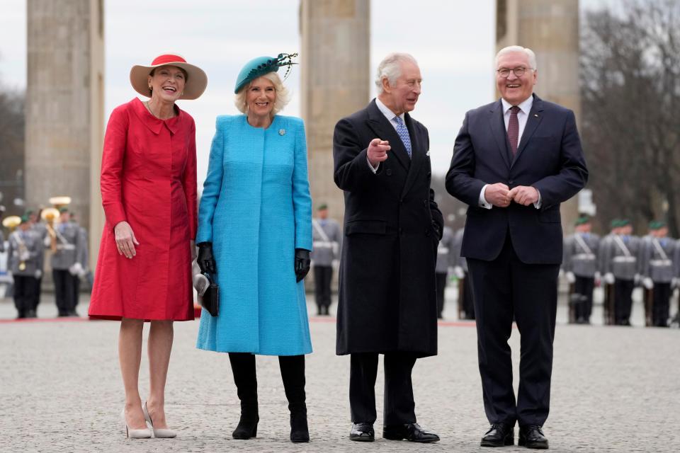 German President Frank-Walter Steinmeier, right, and his wife Elke Buedenbender, left, welcome King Charles III and Queen Consort Camilla in front of the Brandenburg Gate in Berlin on March 29, 2023.