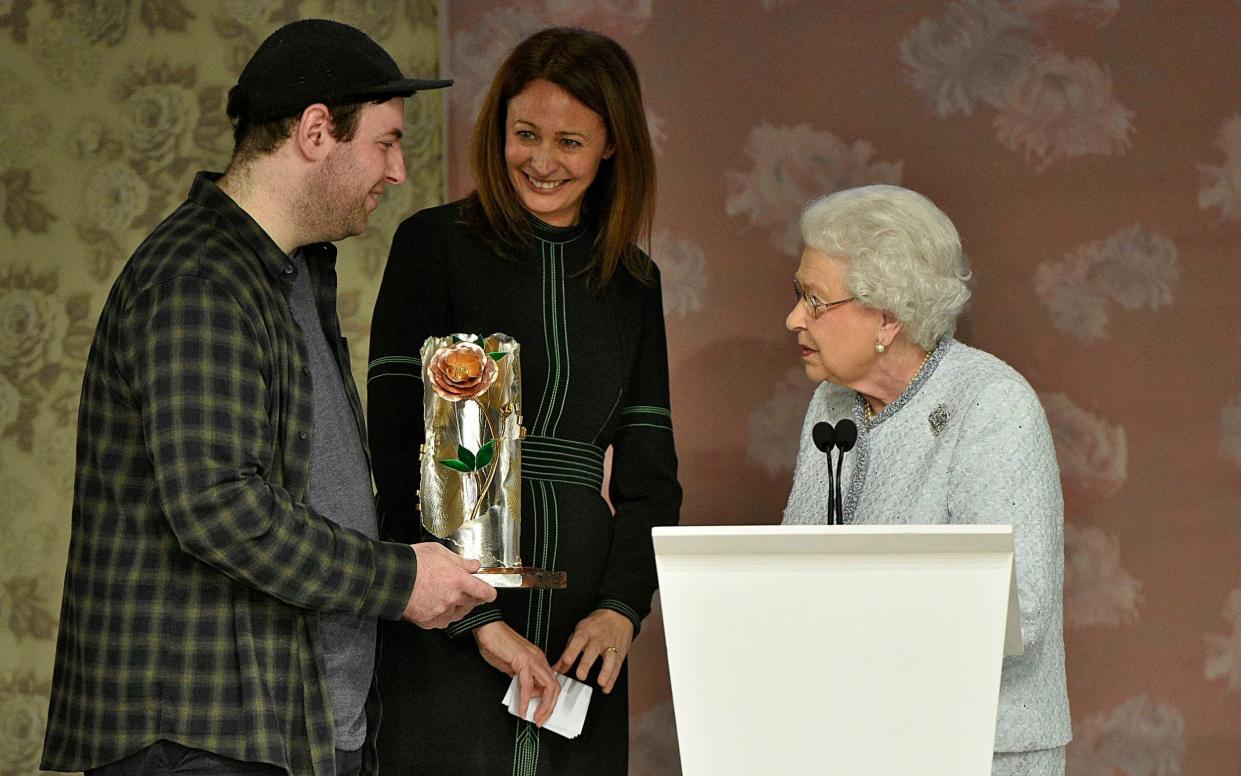 The late Queen presenting the Queen Elizabeth Award for British Design to designer Richard Quinn at London Fashion Week in 2018