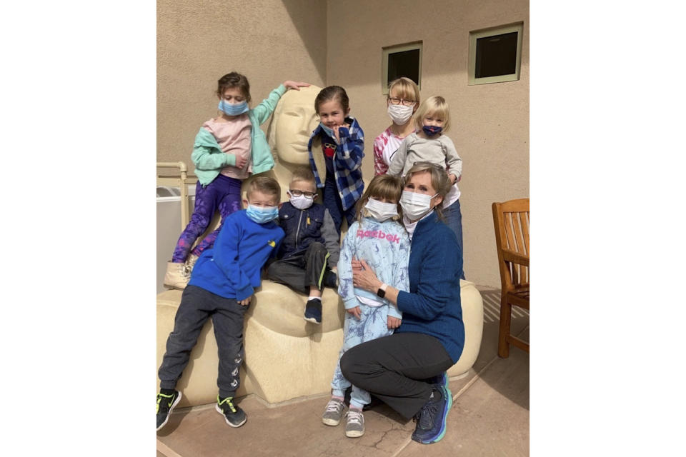 Longtime Farmington, N.M., preschool teacher Melody Ivie, far right, poses with some of her students, including 4-year-old Jerron Pickering, top center. Jerron's father, Sheldon Pickering, grew up a few houses from Ivie and her family. Ivie was among three older women who died May 15, 2023, when an 18-year-old gunman began indiscriminately shooting at vehicles in his Farmington neighborhood. (Sheldon Pickering via AP)