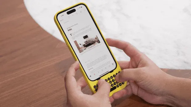 Hands typing on a phone keyboard