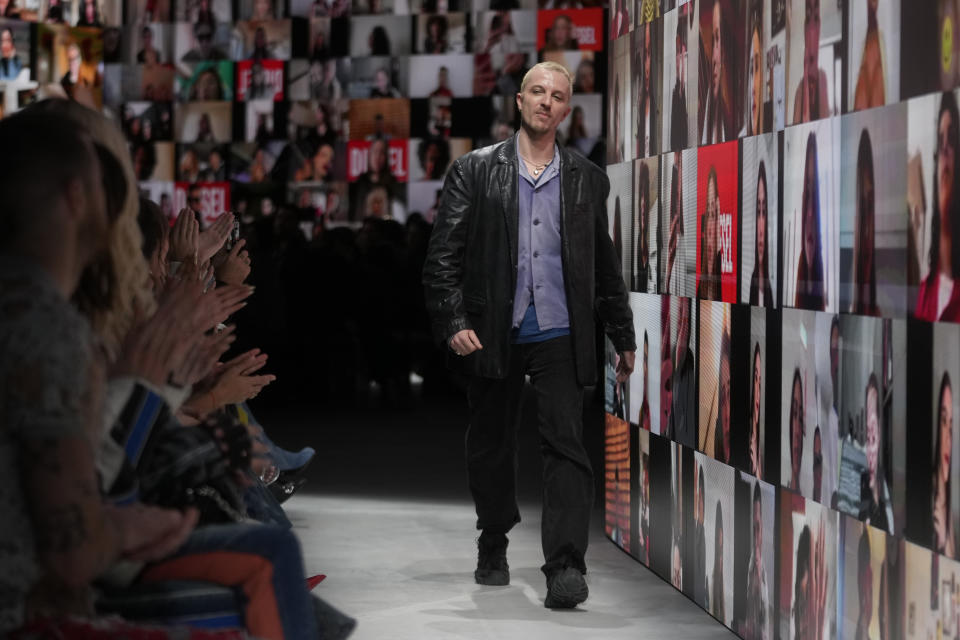 Diesel's creative director Glenn Martens receives the applause at the end of their women's Fall-Winter 2024-25 collection presented in Milan, northern Italy, Wednesday, Feb. 21, 2024. (AP Photo/Luca Bruno)