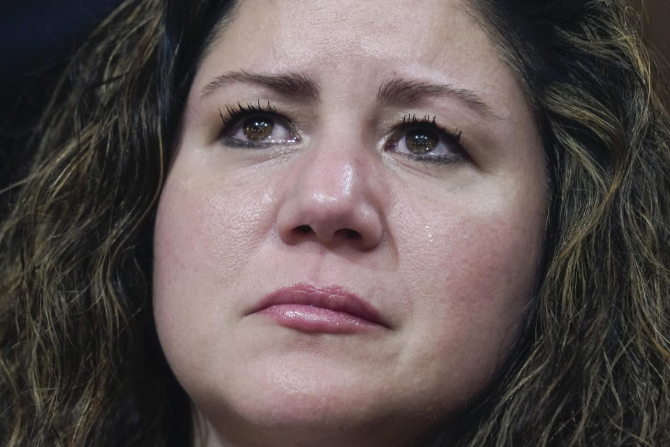 Sandra Garza, the long-time partner of Capitol Hill Police Officer Brian Sicknick who died shortly after the Jan. 6 attack, reacts as a video of the Jan. 6 attack on the U.S. Capitol is played during a public hearing of the House select committee investigating the attack is held on Capitol Hill, Thursday, June 9, 2022, in Washington. (AP Photo/Andrew Harnik)