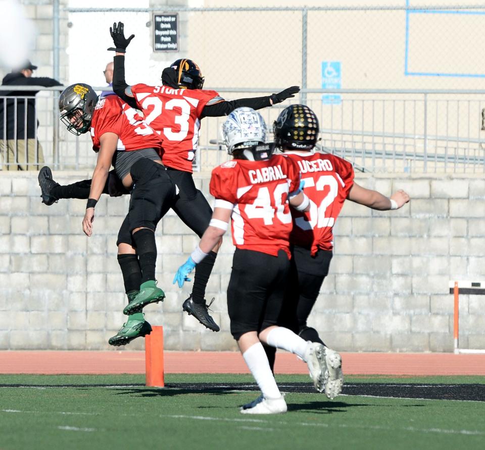 East All-Stars Jakob Medina of Moorpark (left to right), Nolan Story of Newbury Park, Tory Cabral of Fillmore, and Ryan Lucero of Calabasas celebrate Story's interception return for a touchdown during the 49th annual Ventura County All-Star Football Game at Ventura College on Saturday, Feb. 4, 2023. The East won, 39-25.