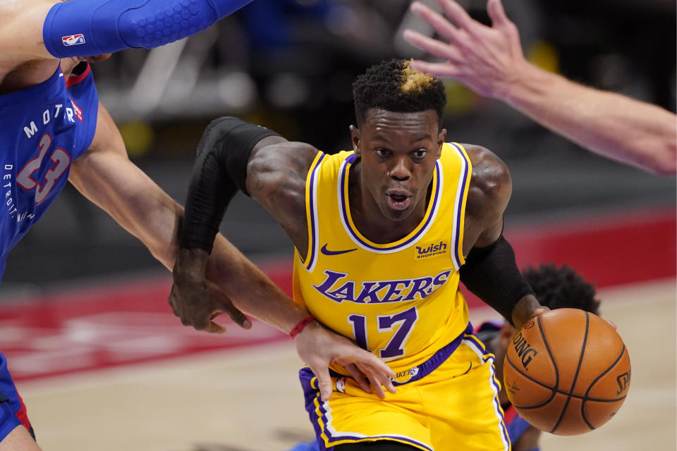 Los Angeles Lakers guard Dennis Schroder (17) drives as Detroit Pistons forward Blake Griffin (23) defends during the first half of an NBA basketball game, Thursday, Jan. 28, 2021, in Detroit. (AP Photo/Carlos Osorio)