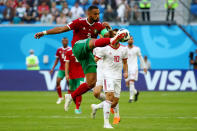 <p>Eye on the ball: Juventus and Morocco star Medhi Benatia clears the ball against Iran. REUTERS/Michael Dalder </p>