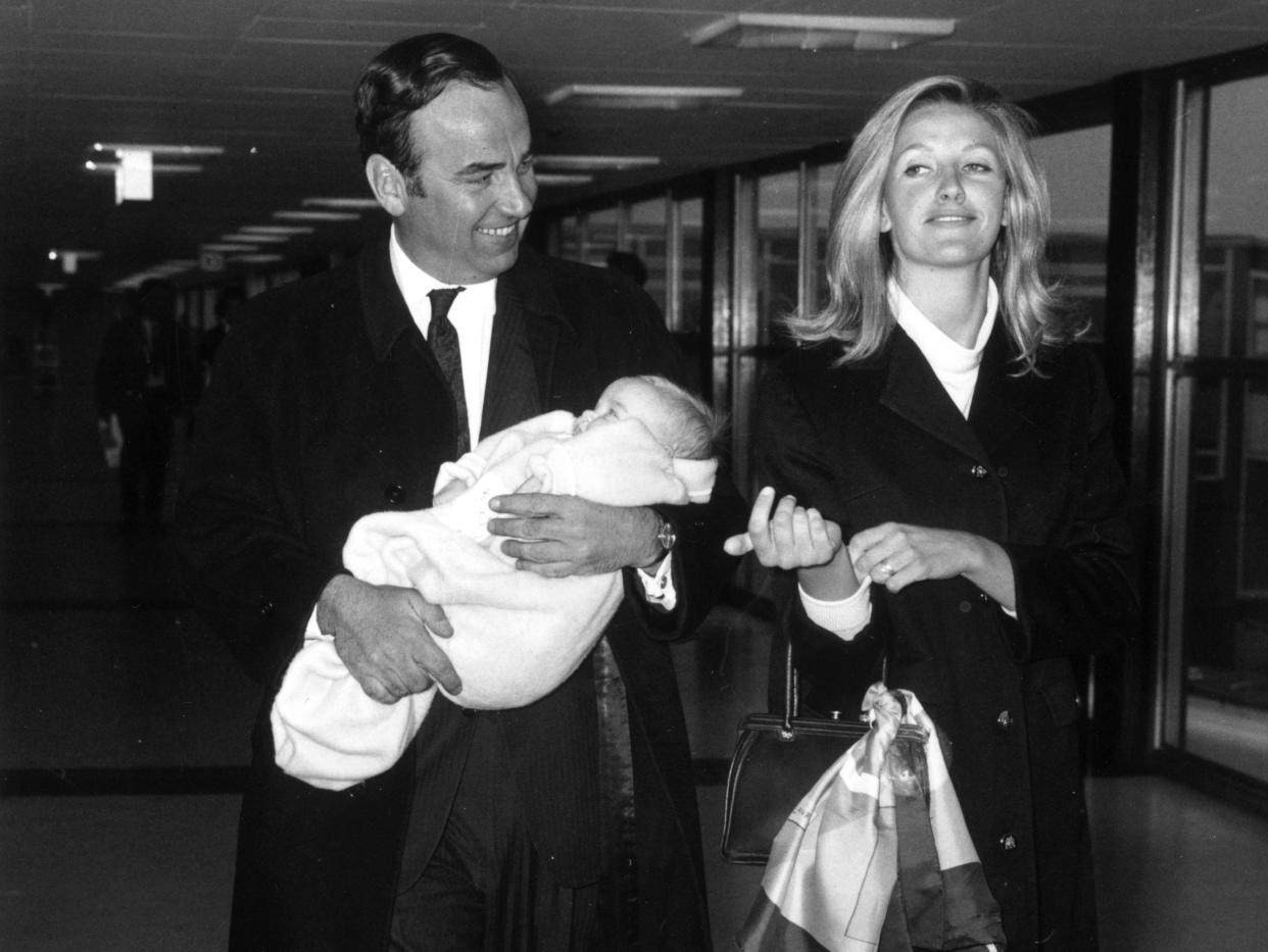 1968: Australian businessman and media tycoon Rupert Murdoch with his wife, Anna and their baby daughter, Elizabeth, at London Airport