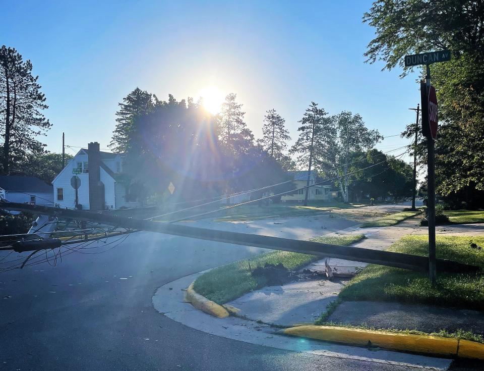 Downed power lines in the city of Oconto are seen Thursday morning.