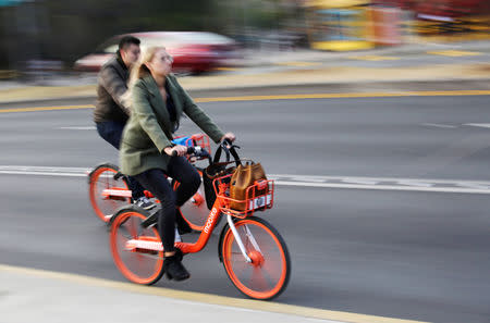 People ride bikes from Chinese bike-sharing company Mobike in Mexico City, Mexico January 10, 2019. REUTERS/Daniel Becerril
