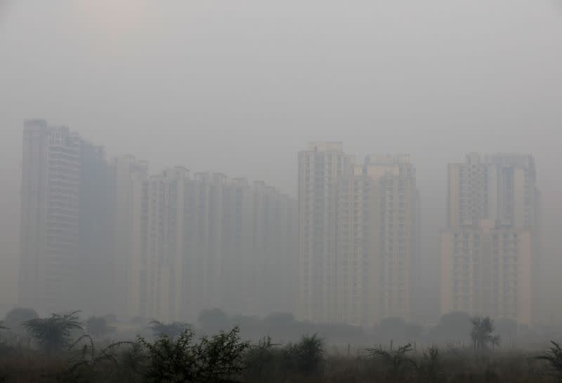 FILE PHOTO: Buildings are engulfed in fog in Noida on the outskirts of New Delhi