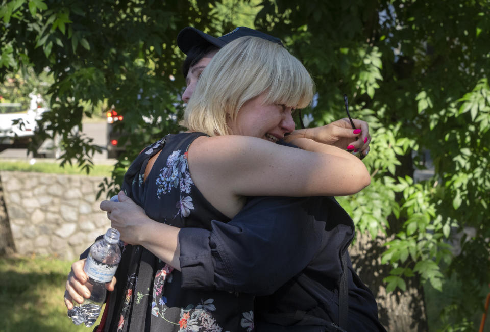 People react at a shopping center burned after a rocket attack in Kremenchuk, Ukraine, Tuesday, June 28, 2022. More than a dozen of people were killed. (AP Photo/Efrem Lukatsky)