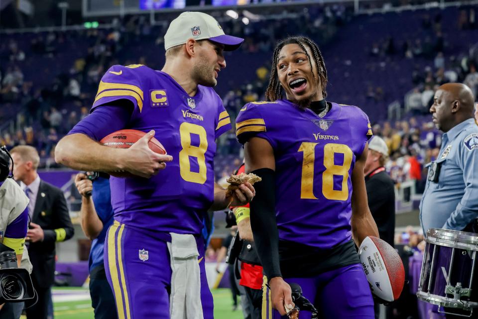 Minnesota Vikings quarterback Kirk Cousins (8) and wide receiver Justin Jefferson (18) walk off the field after an NFL football game against the New England Patriots, Thursday, Nov. 24, 2022 in Minneapolis. (AP Photo/Stacy Bengs)