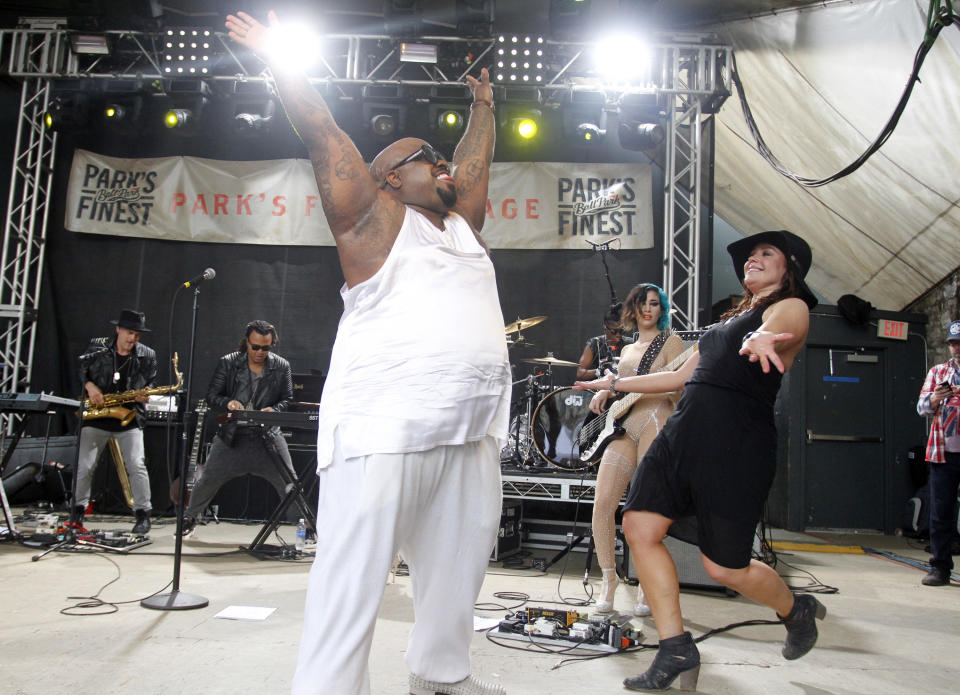 Rachael Ray, right, greets CeeLo Green onstage at her Feedback Party during the SXSW Music Festival, Saturday, March 15, 2014, in Austin, Texas. (Photo by Jack Plunkett/Invision/AP)