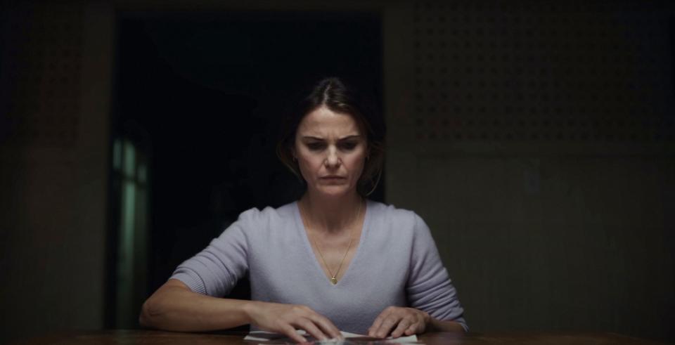 Woman sitting at a table and looking lost in thought