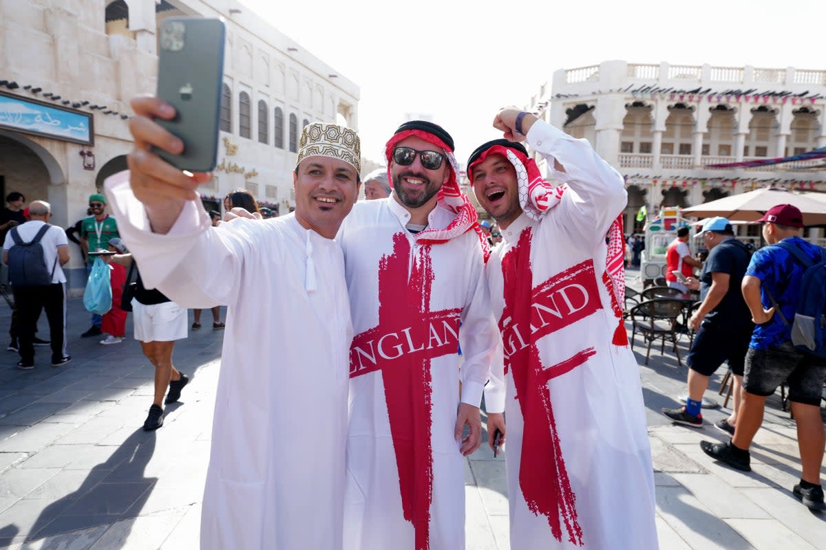 England fans pose for a photograph at a souq in Doha on the day of the FIFA World Cup Group B match between Wales and England (Nick Potts/PA) (PA Wire)