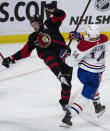 Montreal Canadiens center Nick Suzuki, right, collides with Ottawa Senators defenseman Thomas Chabot, left, in front of the net during second-period NHL hockey game action Saturday, Jan. 28, 2023, in Ottawa, Ontario. (Adrian Wyld/The Canadian Press via AP)