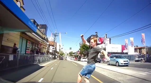 The skater suddenly jumps from his board in fear. Source: YouTube/ Dash Cam Owners Australia