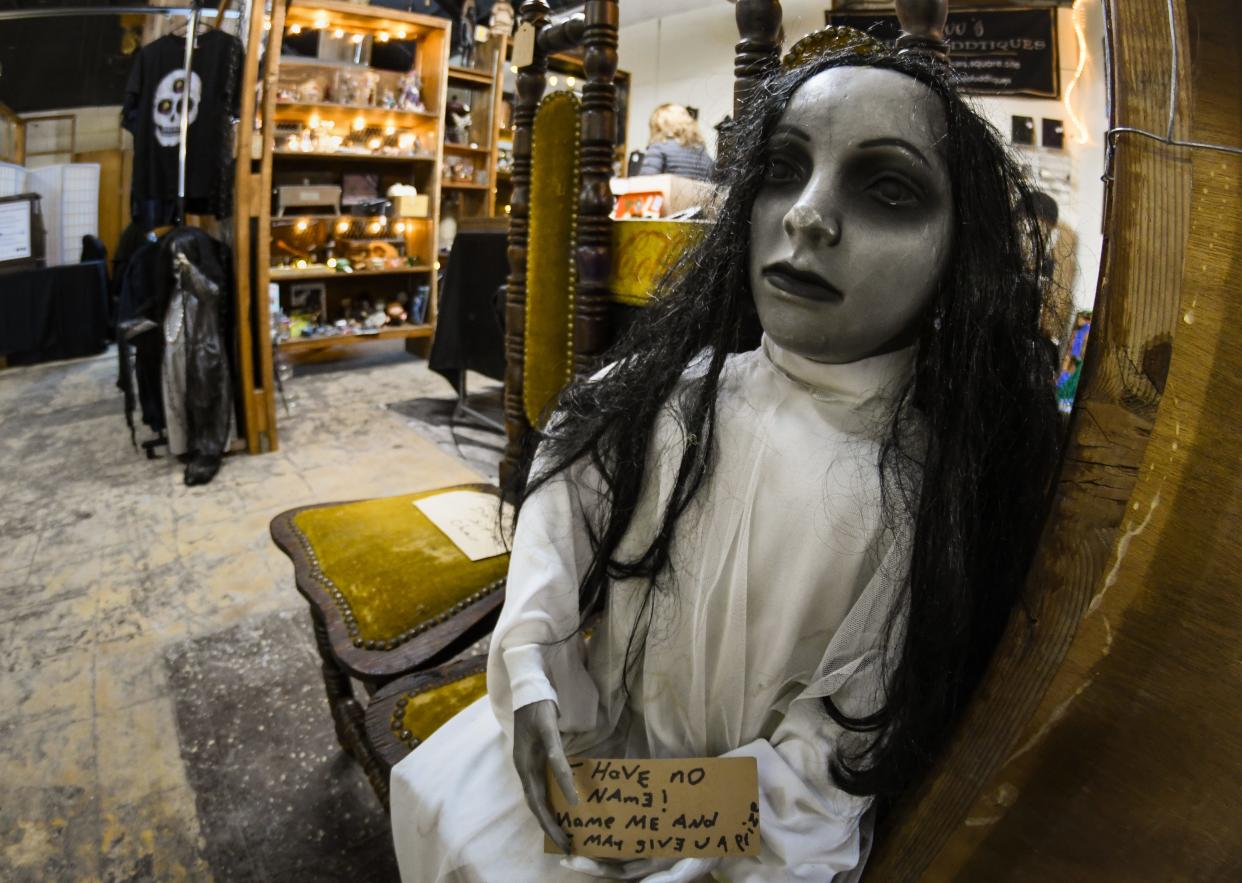 One of two dolls at the entrance of Voodoo's World of Oddtiques shop in the REO Town Marketplace on South Washington Avenue in Lansing, pictured Tuesday, Jan. 11, 2022.