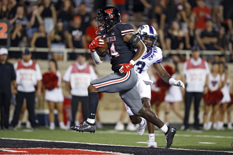 Texas Tech's Xavier White (14) scores a touchdown during the second half of the team's NCAA college football game against TCU, Saturday, Oct. 9, 2021, in Lubbock, Texas. (AP Photo/Brad Tollefson)