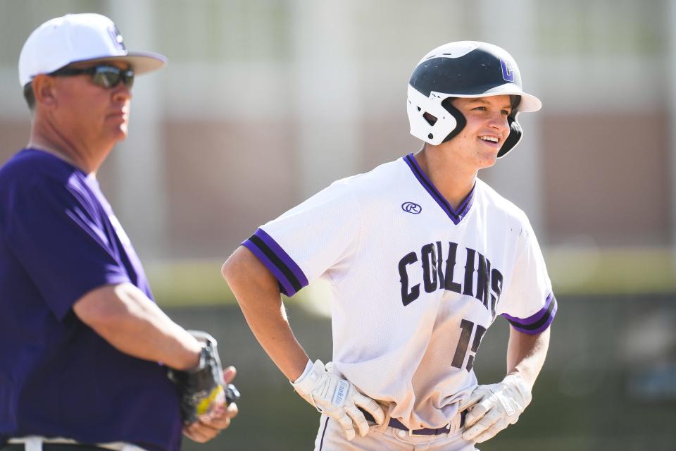 Fort Collins' Jude Miller (15) smiles after reaching third base during a high school baseball game against Fossil Ridge at Fort Collins High School on April 18, 2023. The Lambkins won 2-1.