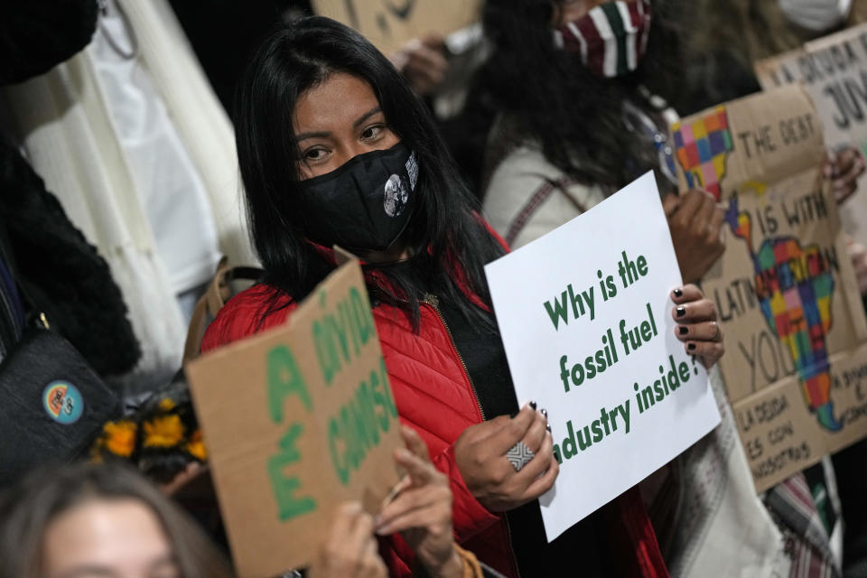 FILE - Youth climate activists protest that representatives of the fossil fuel industry have been allowed inside the venue during the COP26 U.N. Climate Summit in Glasgow, Scotland, Thursday, Nov. 11, 2021. (AP Photo/Alastair Grant, File)