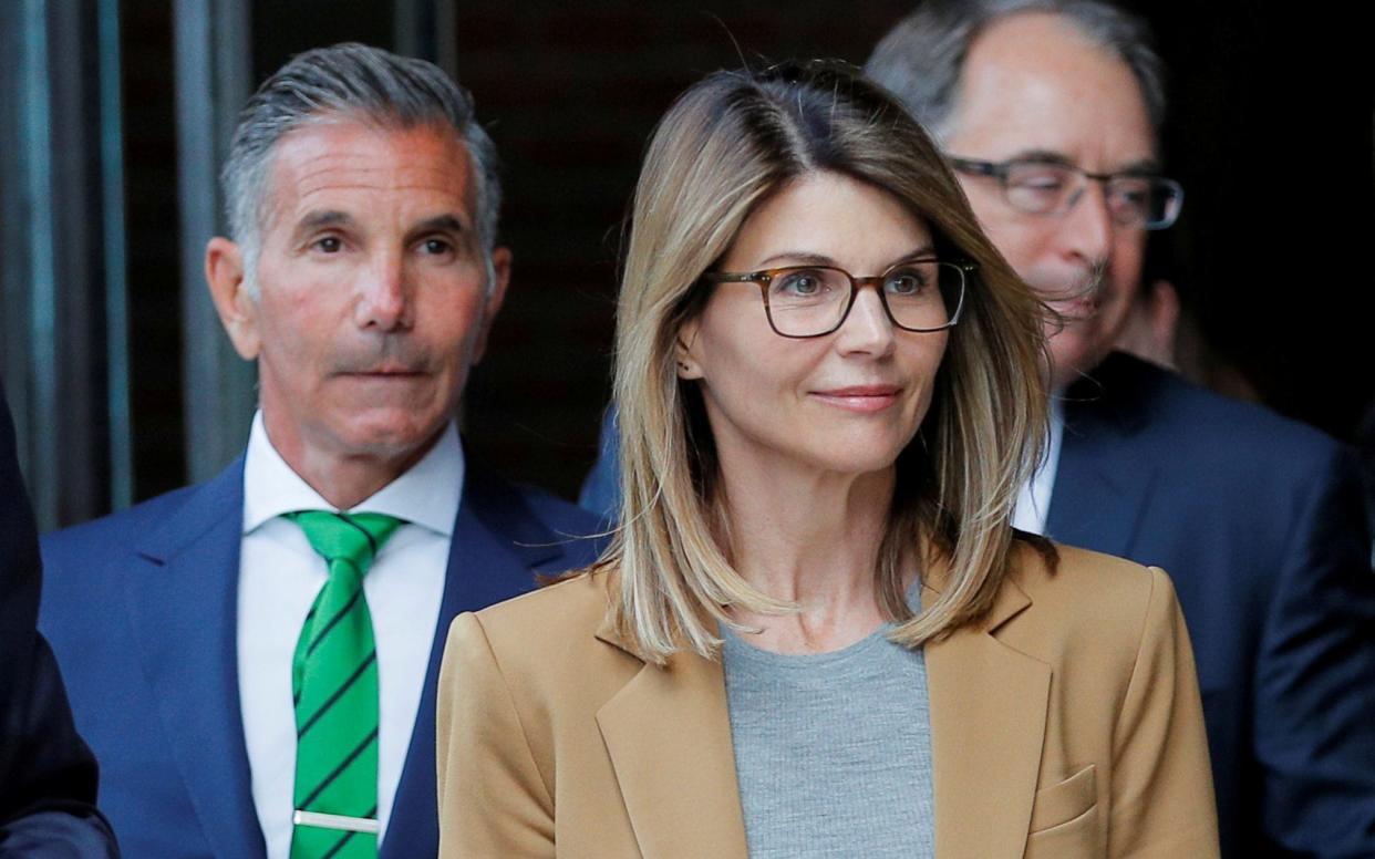 Actor Lori Loughlin and her husband Mossimo Giannulli leave the federal courthouse in Boston - REUTERS