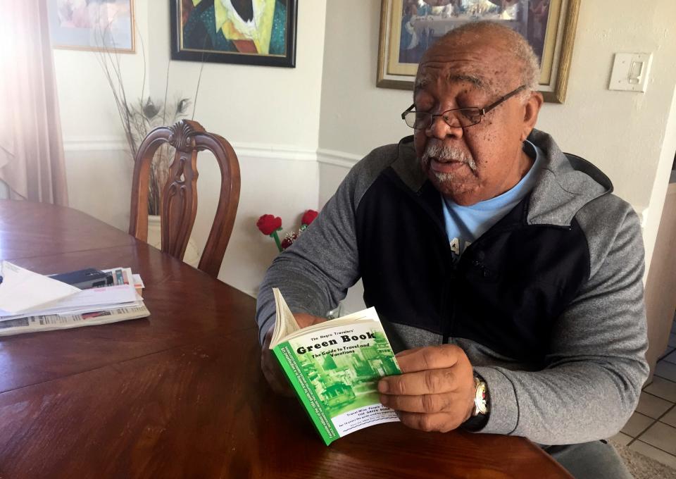 In this Jan. 31, 2019 photo, Charles Becknell, Sr., 77, holds a copy of the 1954 edition of "The Negro Motorist Green Book" at his home in Rio Rancho, New Mexico.