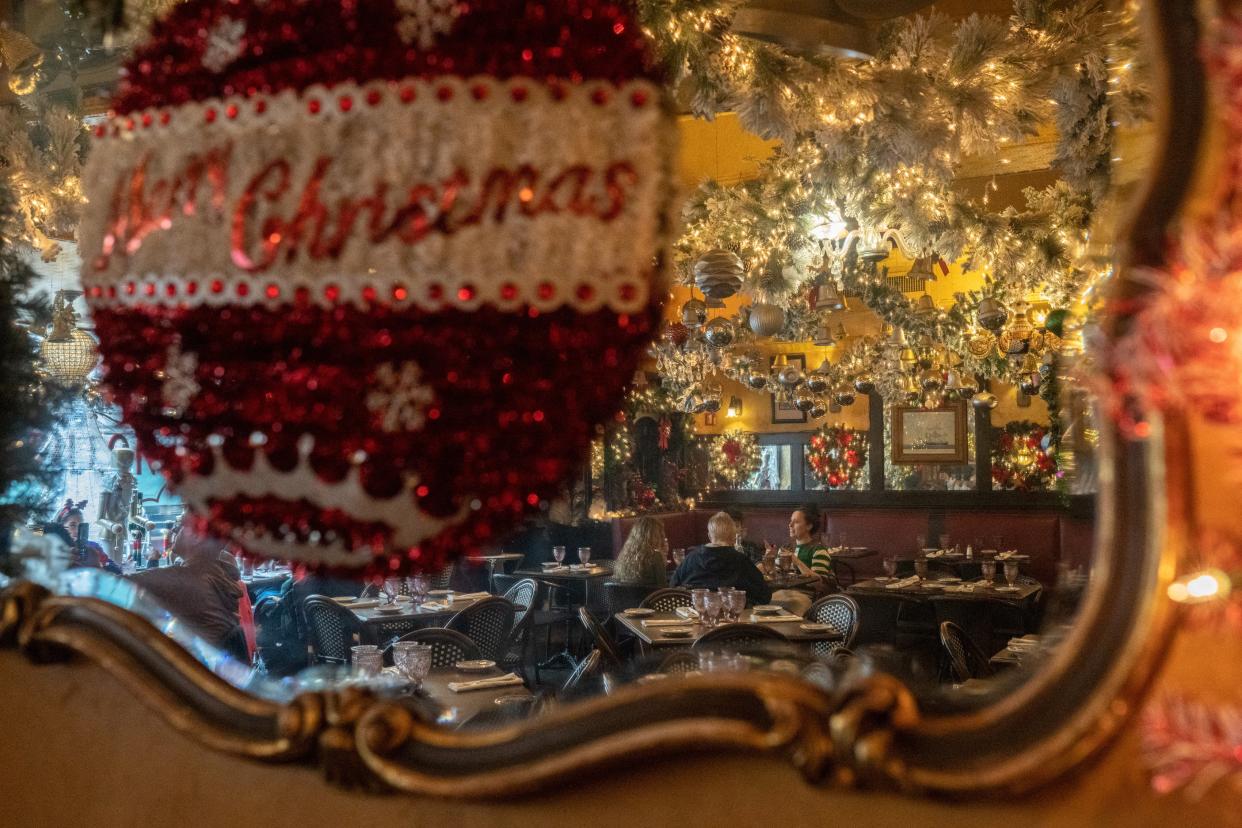 People reflected in a mirror at a restaurant on Christmas Eve in the US this year (REUTERS)