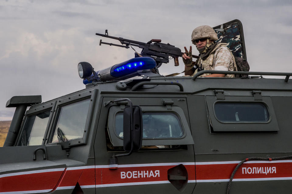 Russian soldier mans a machine gun during a patrol near Syrian and Turkish border in north Syria, Friday. Oct. 25, 2019. (AP Photo/Baderkhan Ahmad)