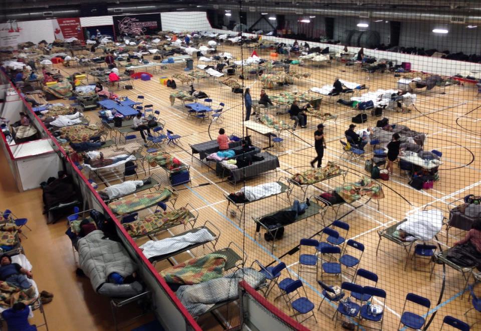 Cots are set at an evacuee reception center