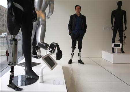 Professor Hugh Herr, who heads the Biomechatronics research group at the MIT Media Lab, stands amid mannequins displaying various bionic limbs his lab has developed at the Massachusetts Institute of Technology in Cambridge, Massachusetts April 4, 2014. REUTERS/Brian Snyder
