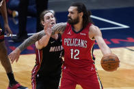 New Orleans Pelicans center Steven Adams (12) looks to pass the ball as Miami Heat forward Kelly Olynyk (9) defends during the first half of an NBA basketball game in New Orleans, Thursday, March 4, 2021. (AP Photo/Gerald Herbert)