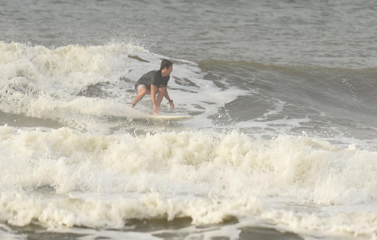 Surfers enjoy the surf near the Ocean Crest Pier in Oak Island, N.C., Aug. 29, 2017, after a tropical disturbance moved through the area bring rain and heavy surf.