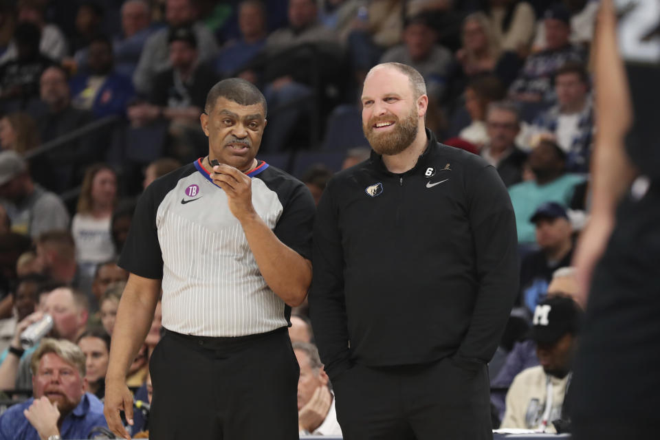 Memphis Grizzlies coach Taylor Jenkins, right, talks with official Tony Brothers during the first half of the team's NBA basketball game against the Detroit Pistons on Friday, Dec. 9, 2022, in Memphis, Tenn. (AP Photo/Nikki Boertman)