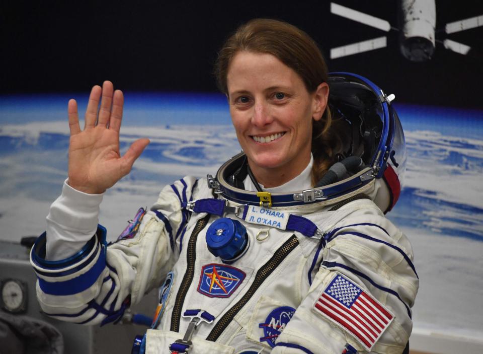 US NASA astronaut Loral O'Hara, a member of the International Space Station (ISS) Expedition 70-71 main crew, waves as her spacesuit is tested during the pre-launch preparationsin Kazakhstan on September 2023.