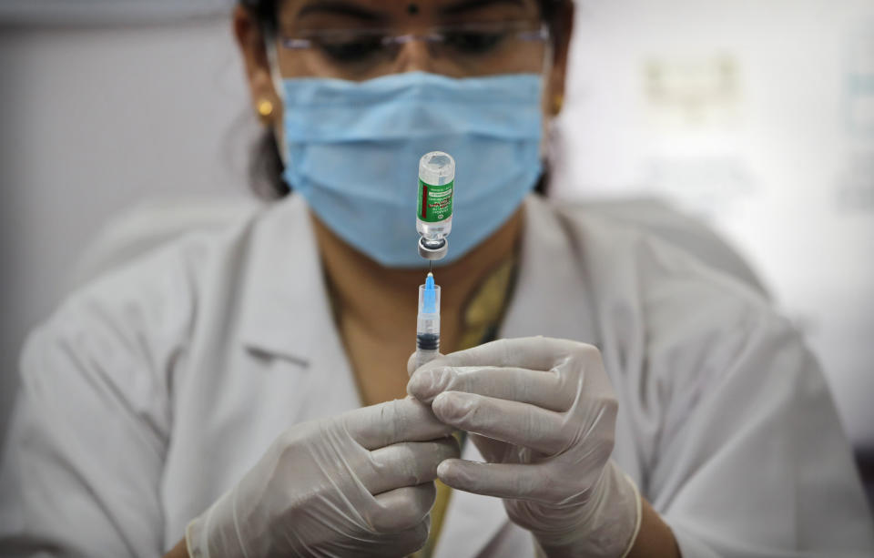 FILE- In this Feb. 11, 2021 file photo, a health worker prepares to administer a COVID-19 vaccine at a hospital in New Delhi, India. India has expanded its COVID-19 vaccination drive, beyond health care and frontline workers to the general population. Now, those who are older than 60 and people, above the age of 45 — with ailments like heart disease or diabetes that make them vulnerable to the virus — can get the shots. (AP Photo/Manish Swarup, File)