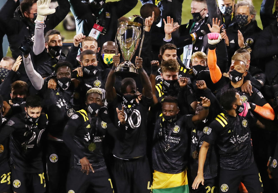 Dec 12, 2020; Columbus, Ohio, USA; Columbus Crew defender Jonathan Mensah (4) hoists the MLS Cup championship trophy after defeating the Seattle Sounders in the 2020 MLS Cup Final at MAPFRE Stadium. Mandatory Credit: Aaron Doster-USA TODAY Sports