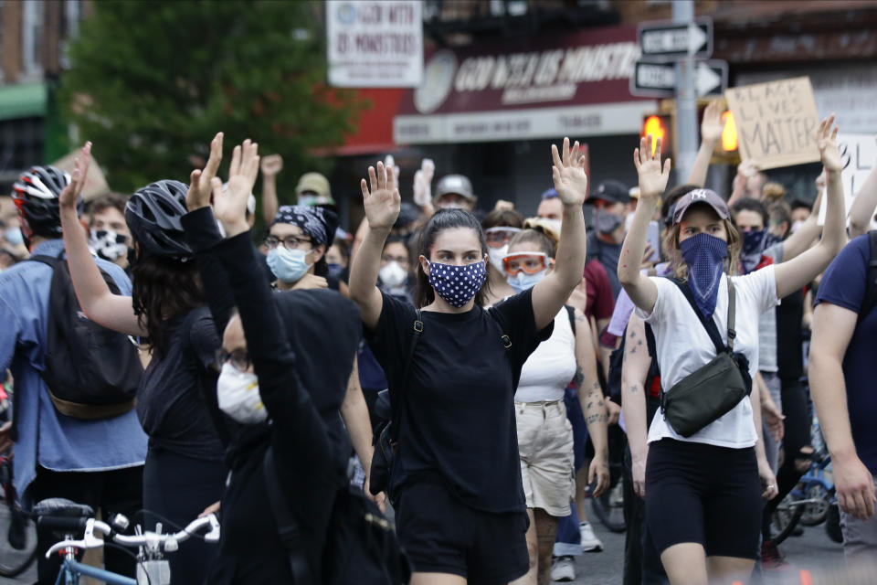 Protesters march during a solidarity rally for George Floyd, Thursday, June 4, 2020, in the Brooklyn borough of New York. Floyd died after being restrained by Minneapolis police officers on May 25. (AP Photo/Frank Franklin II)