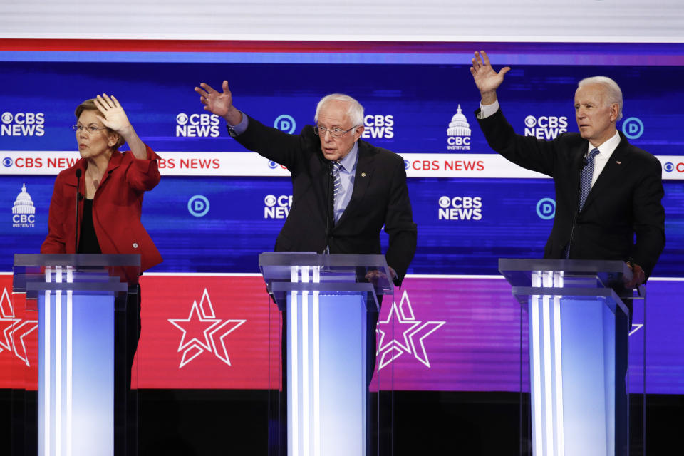 From left, Democratic presidential candidates, Sen. Elizabeth Warren, D-Mass., Sen. Bernie Sanders, I-Vt., and former Vice President Joe Biden, raises their hands as they participate in a Democratic presidential primary debate at the Gaillard Center, Tuesday, Feb. 25, 2020, in Charleston, S.C., co-hosted by CBS News and the Congressional Black Caucus Institute. (AP Photo/Patrick Semansky)