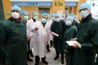 Experts from China and the World Health Organization (WHO) joint team wearing face masks visit the Wuhan Tongji Hospital in Wuhan, the epicentre of the novel coronavirus outbreak, in Hubei