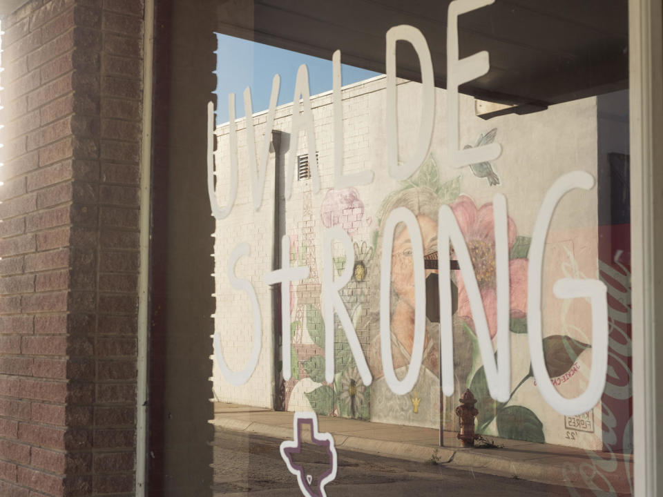 A mural of Jackie Cazares is reflected in a window inscribed with the phrase “Uvalde Strong,” on April 25, 2023 in Uvalde, Texas. (Jordan Vonderhaar for NBC News)