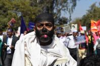 <p>An Indian protester wearing black facepaint walks alongside students and activists during a protest in New Delhi on February 23, 2016. Students from different Indian universities are taking part in rallies in the Indian capital following the death of Hyderabad University Dalit scholar, Rohit Vemula, 26, who allegedly committed suicide on January 17, after authorities suspended him and five of his friends over a tiff with a right-wing student political group. </p>