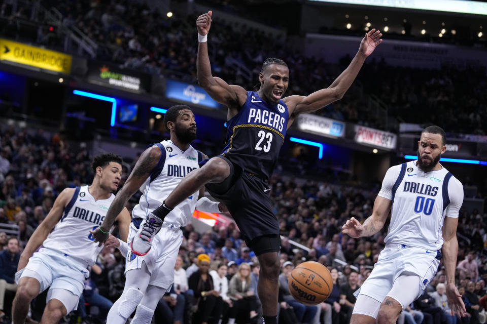 Indiana Pacers forward Aaron Nesmith (23) looses the ball in front of Dallas Mavericks center JaVale McGee (00) during the second half of an NBA basketball game in Indianapolis, Monday, March 27, 2023. The Mavericks defeated the Pacers 127-104. (AP Photo/Michael Conroy)