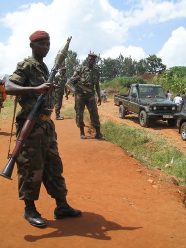 Burundian soldiers stand at a check point in Kabezi, 20 km south of Bujumbura. Monday will see the police and army march across Burundi's capital in brand new Chinese-made uniforms, estimated to have cost the country $1.5 mn
