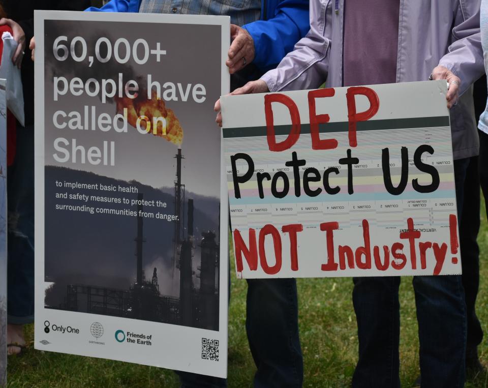 Activists hold signs at a Beaver County rally organized to call for more transparency and accountability at Shell's ethane cracker plant in Beaver's Irvine Park on June 8, 2023.