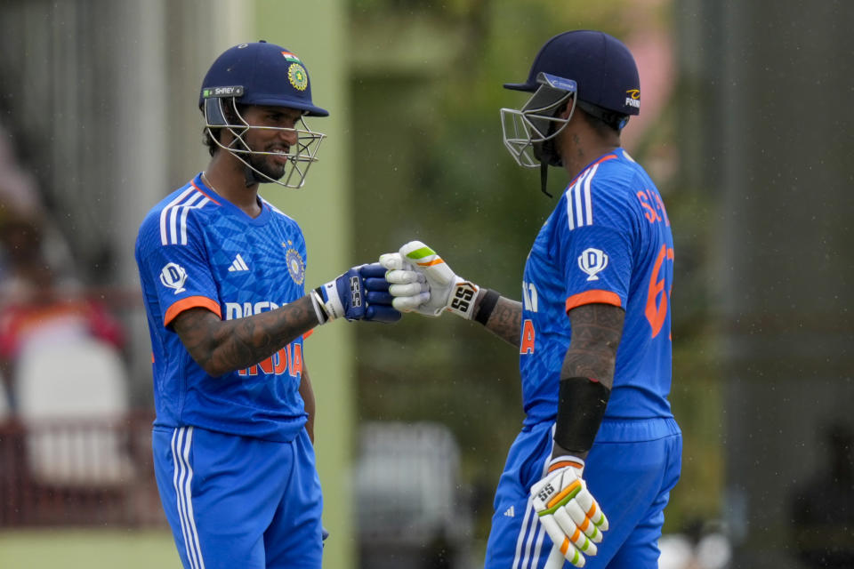 India's Tilak Varma, left, and India's Suryakumar Yadav knock gloves during the third T20 cricket match against West Indies at Providence Stadium in Georgetown, Trinidad and Tobago, Tuesday, Aug. 8, 2023. (AP Photo/Ramon Espinosa)