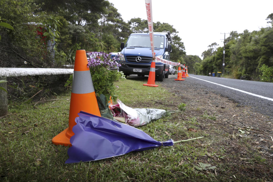 Flowers lie near where the body of missing British tourist Grace Millane was discovered on Scenic Drive in the Waitakere Ranges outside Auckland, New Zealand, Monday, Dec. 10, 2018. New Zealand police said Sunday that they found the body they believe is that of 22-year-old Millane in a forested area about 10 meters (33 feet) from the side of the road in the Waitakere Ranges. (Doug Sherring/New Zealand Herald via AP)