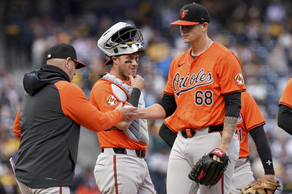 Baltimore Orioles manager Brandon Hyde, left, removes starting pitcher Tyler Wells (68) during the sixth inning of a baseball game against the Pittsburgh Pirates, Saturday, April 6, 2024, in Pittsburgh. (AP Photo/Matt Freed)