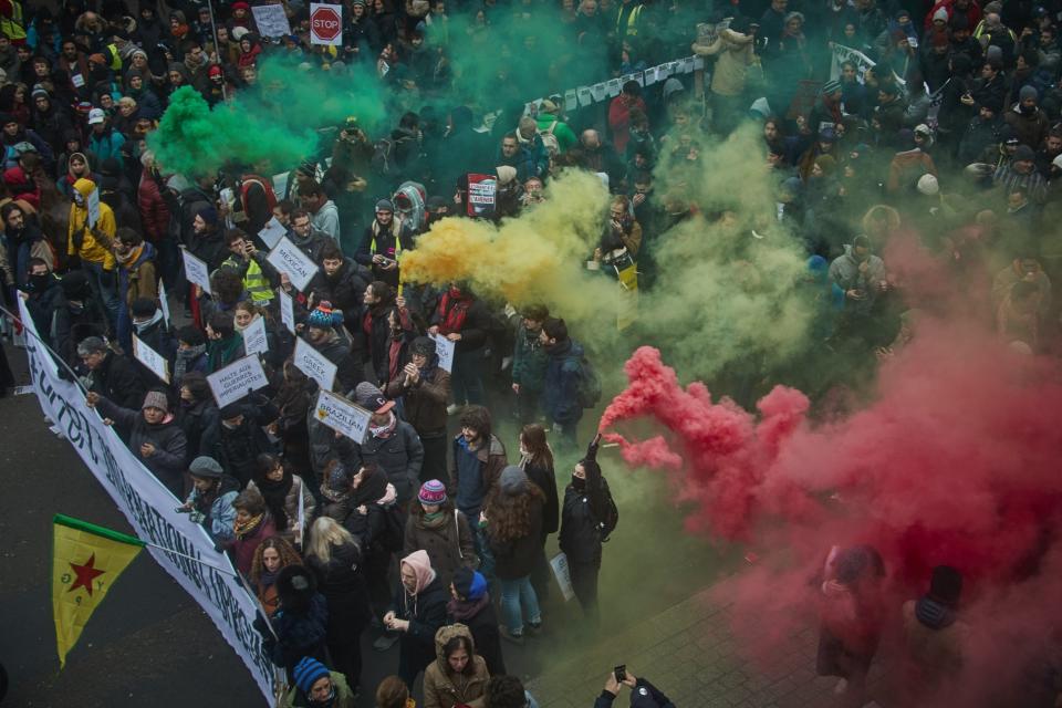 Protestors wave coloured flares during a rally near Place de Republique in support of the national strike in France (Getty Images)