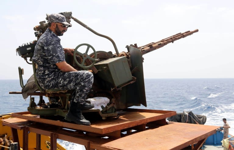 A member of the Libyan coastguard mans a machinegun on a patrol boat off the coast of Misrata on May 9, 2015