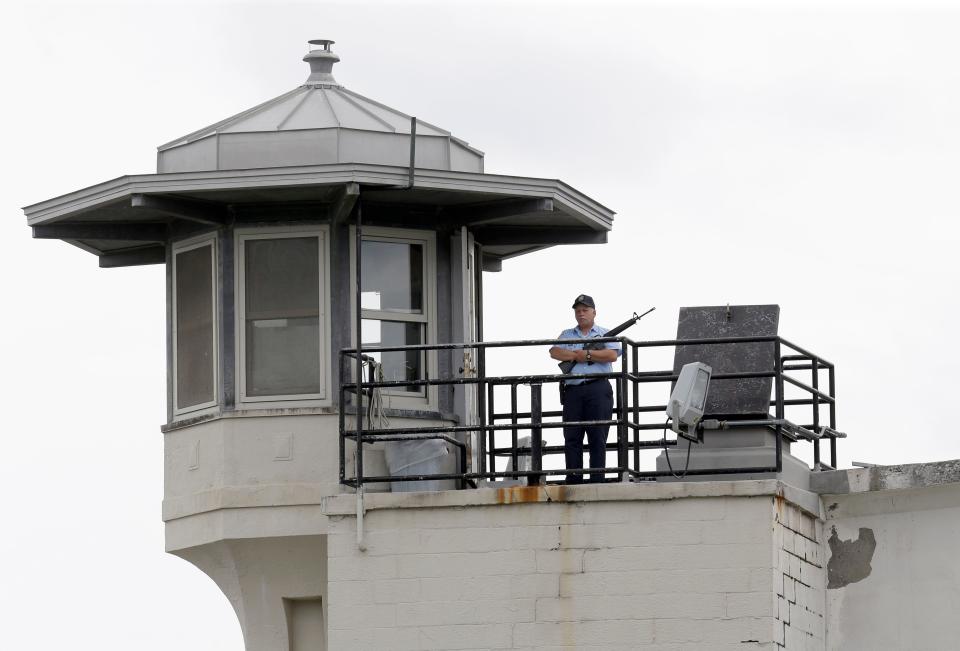 A prison employee stands guard on a tower at the Clinton Correctional Facility in Dannemora, N.Y., Wednesday, June 10, 2015. Police were resuming house-to-house searches near the maximum-security prison in northern New York where two killers escaped using power tools, authorities said Wednesday as they renewed their plea for help from the public. (AP Photo/Seth Wenig)